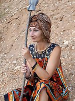 With spear wearing in colorful dress